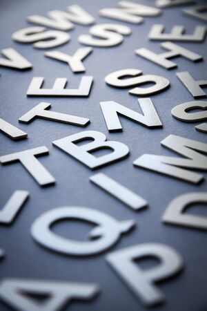 Mixed solid letters pile closeup photo. Education background conceptの写真素材