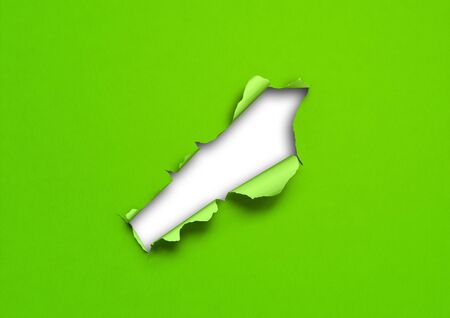 Green torn paper with hole. blank background templateの写真素材