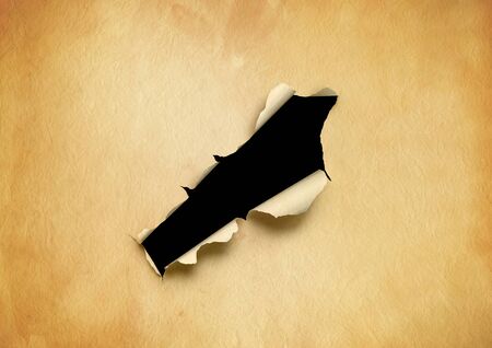 Old torn parchment paper with black hole. blank background templateの写真素材
