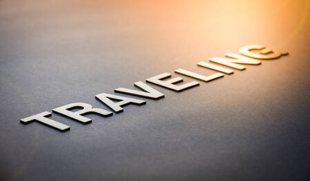 Word traveling written with white solid letters on a boardの写真素材