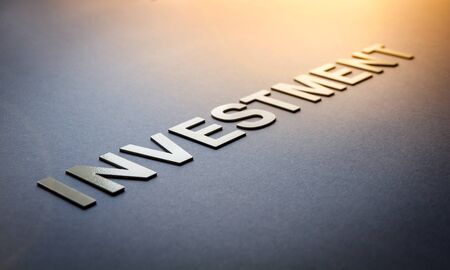 Word investment written with white solid letters on a boardの写真素材