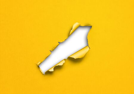 Yellow torn paper with hole. blank background templateの写真素材