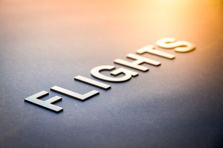 Word flights written with white solid letters on a boardの写真素材