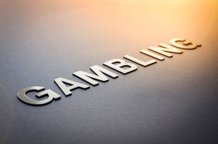 Word gambling written with white solid letters on a boardの写真素材