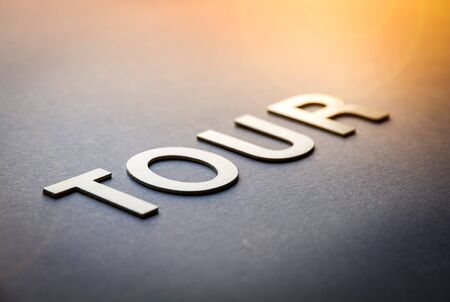 Word tour written with white solid letters on a boardの写真素材