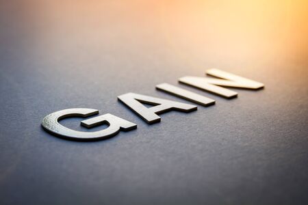 Word gain written with white solid letters on a boardの写真素材