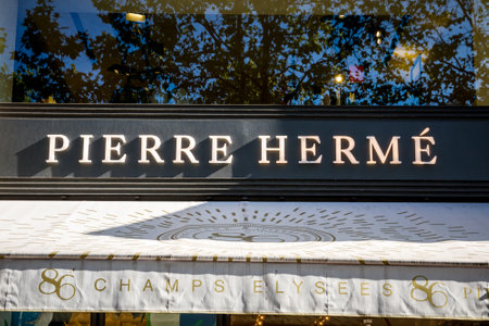 Paris/France - September 10, 2019 : The Pierre Herme pastry store entrance sign on Champs-Elysees avenueのeditorial素材