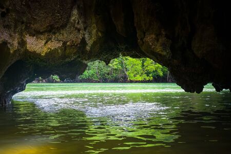 Caves in limestone cliffs, Phang Nga Bay, Thailandの写真素材