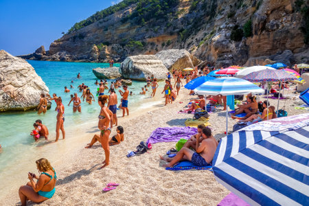 Sardinia/Italy - August 26, 2019 - Crowd of tourists on Cala Mariolu beach in the Golf of Oroseiのeditorial素材