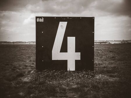 Number 4 countdown panel on Templehof Airport runway, Berlin, Germany. Black and white pictureの写真素材