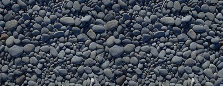 pebbles on a beach background texture. Banner wallpaper                               の写真素材