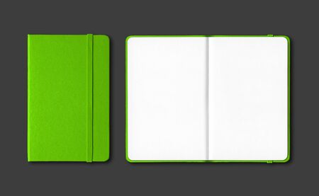 Green closed and open notebooks mockup isolated on blackの写真素材