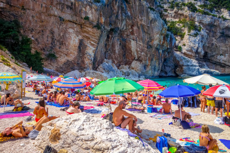 Sardinia/Italy - August 26, 2019 - Crowd of tourists on Cala Mariolu beach in the Golf of Oroseiのeditorial素材