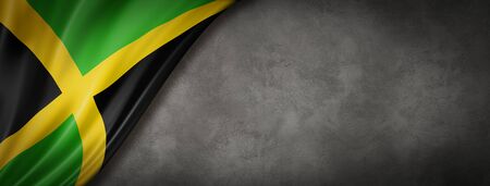 Jamaica flag on concrete wall. Horizontal panoramic banner. 3D illustrationの写真素材