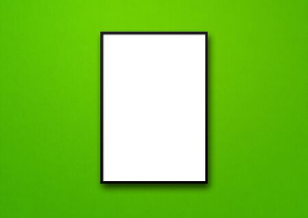 Black picture frame hanging on a green wall. Blank mockup templateの写真素材