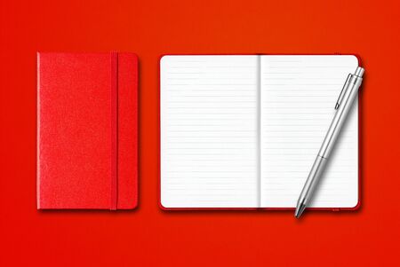 Red closed and open lined notebooks with a pen isolated on colorful backgroundの写真素材