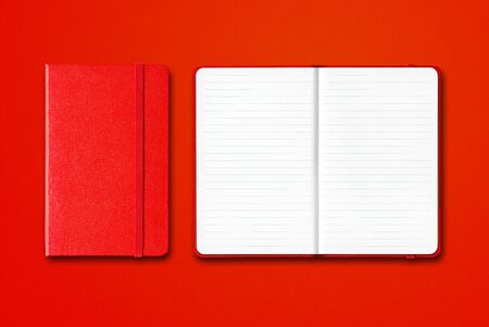 Red closed and open lined notebooks mockup isolated on colorful backgroundの写真素材