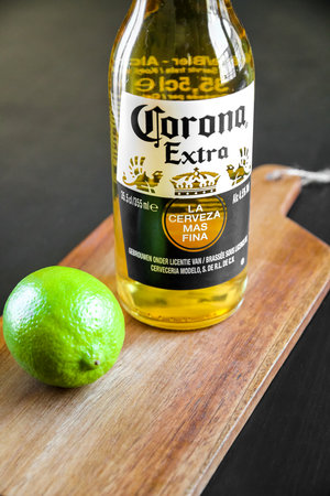 Paris/France - January 6, 2020 : Bottle of Corona Mexican beer and lime on a wooden cutting boardのeditorial素材