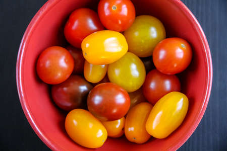 Colorful cocktail tomatoes in a bowl. Top viewの写真素材
