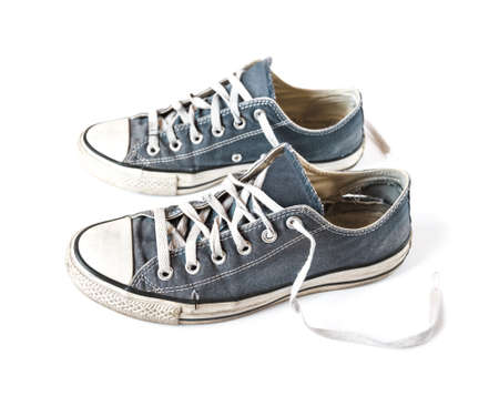 Old blue generic sneakers isolated on white backgroundの写真素材