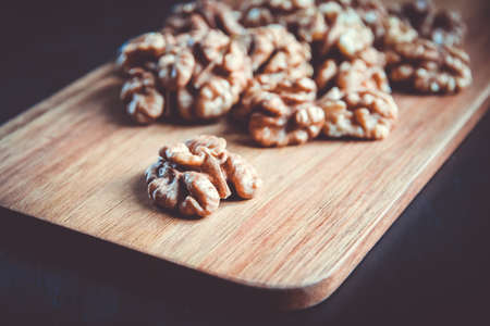 Walnut kernels on a wooden cutting boardの写真素材