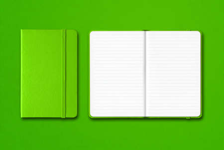 Green closed and open lined notebooks mockup isolated on colorful backgroundの写真素材