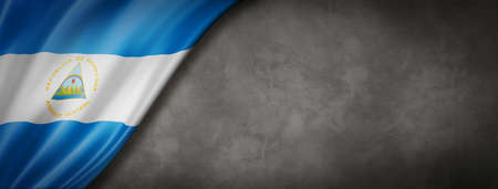 Nicaragua flag on concrete wall. Horizontal panoramic banner. 3D illustrationの写真素材