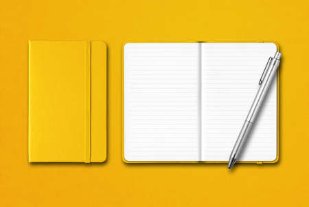 Yellow closed and open lined notebooks with a pen isolated on colorful backgroundの写真素材