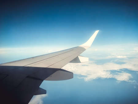 Sky and clouds view from inside an airliner planeの写真素材