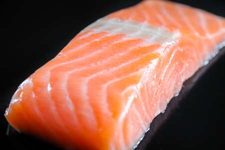 Salmon steak isolated on a black background.の写真素材