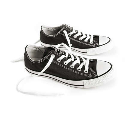 Black generic sneakers isolated on white backgroundの写真素材