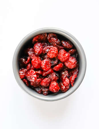 Cranberries in a bowl isolated on white background. Top viewの写真素材
