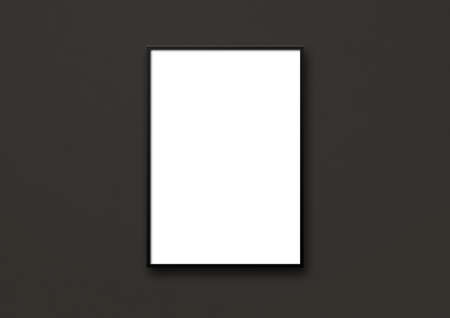 Blank picture frame hanging on a black wall. Presentation mockup templateの写真素材