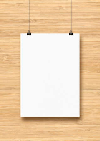 White poster hanging on a wooden wall with clips. Blank mockup templateの写真素材