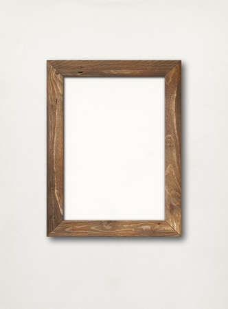 Old brown rustic wooden picture frame hanging on a white wall. Blank mockup templateの写真素材