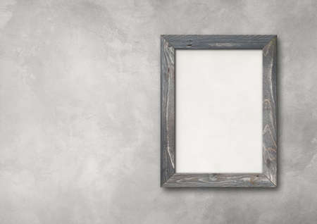Old grey rustic wooden picture frame hanging on a concrete wall. Horizontal banner. Blank mockup templateの写真素材