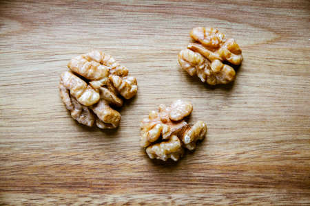 Walnut kernels on a wooden cutting board. Top viewの写真素材