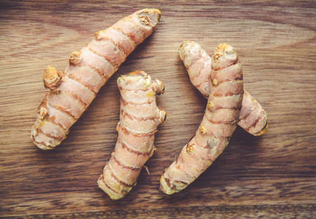 Turmeric root on a wooden cutting board