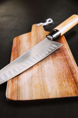 Traditional Japanese gyuto chief knife on a cutting board.の写真素材
