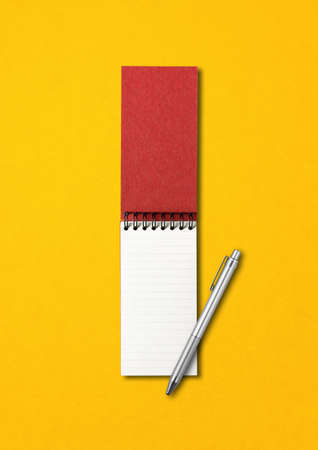 Blank open spiral notebook and pen mockup isolated on yellowの写真素材