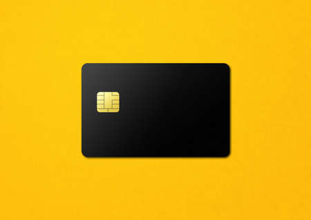 Black credit card template on yellow background. 3D illustrationの写真素材