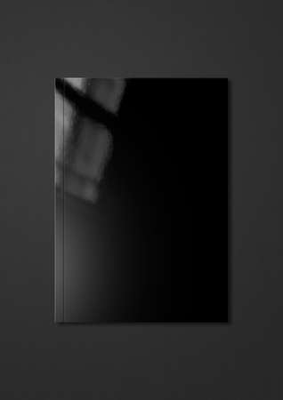 Black booklet cover isolated on dark gray background, mockup templateの写真素材
