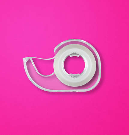Transparent  tape dispenser isolated on pink background