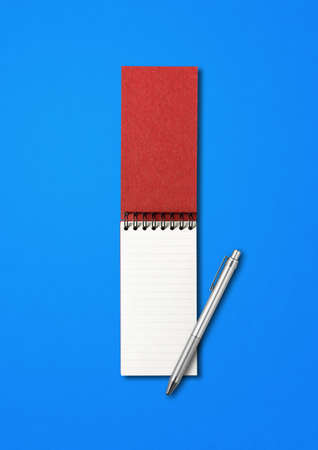 Blank open spiral notebook and pen mockup isolated on blueの写真素材
