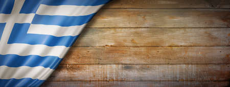 Greece flag on vintage wood wall. Horizontal panoramic banner.の写真素材