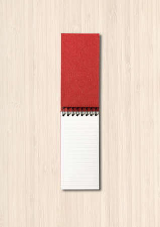 Blank open spiral notebook mockup isolated on white wooden background