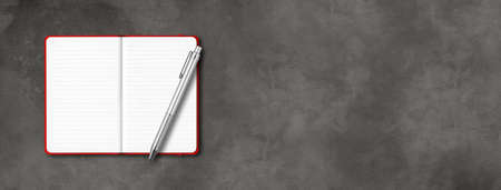 Red open lined notebook mockup with a pen isolated on dark concrete background. Horizontal bannerの写真素材