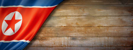 North Korea flag on vintage wood wall. Horizontal panoramic banner.の写真素材