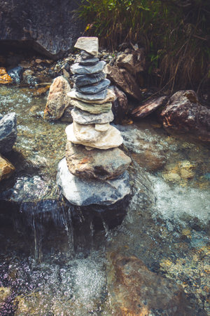Cairn on a river in Vanoise national Park valley, Savoy, French alps