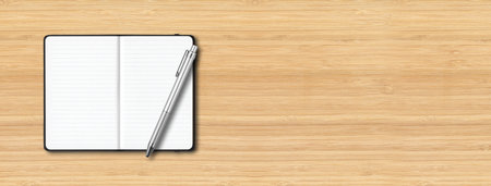 Black open lined notebook mockup with a pen isolated on wooden background. Horizontal bannerの写真素材